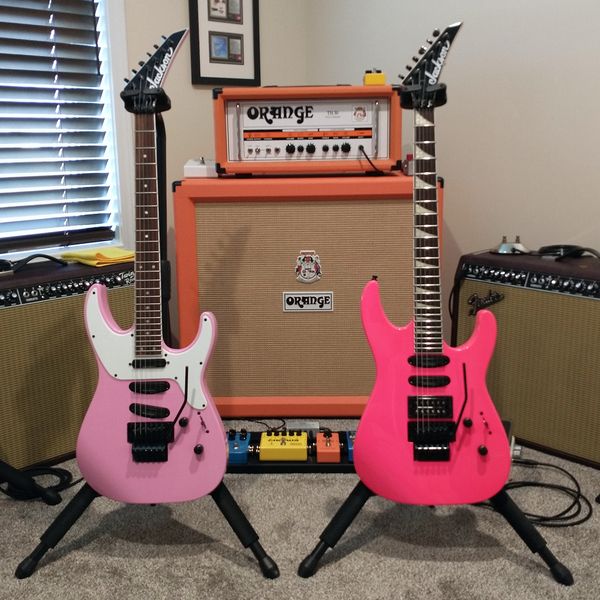 The '80s called. They'd like their guitars back. At right a Jackson X Series Soloist SL4X (with an Original Floyd Rose) in Bubble Gum Pink a Jackson X Series SL3X SX Soloist in Screamin' Neon Pink. 