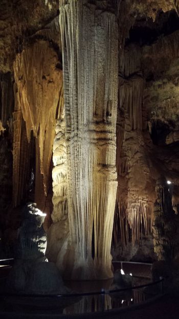 Stalactites hang downwards from the ceiling of caves. Stalagmites rise upwards from the floor. When they meet, columns are formed.

